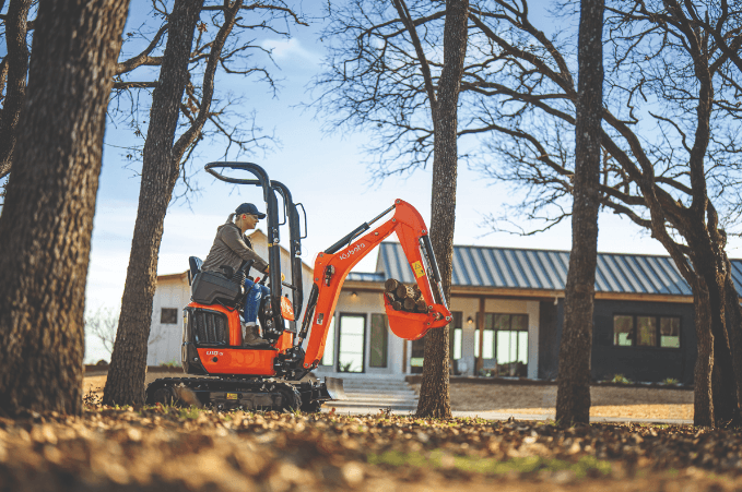 Woman operating a Kubota excavator