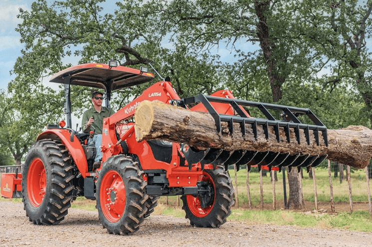 Tractor moving branches