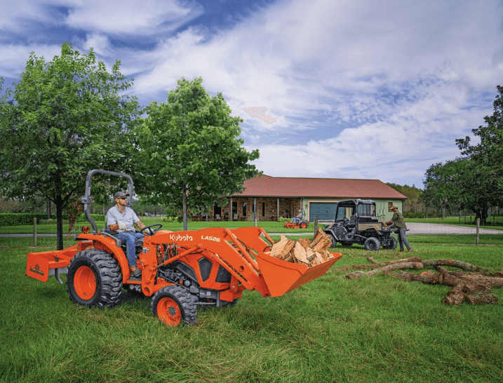 Man using tractor to move firewood