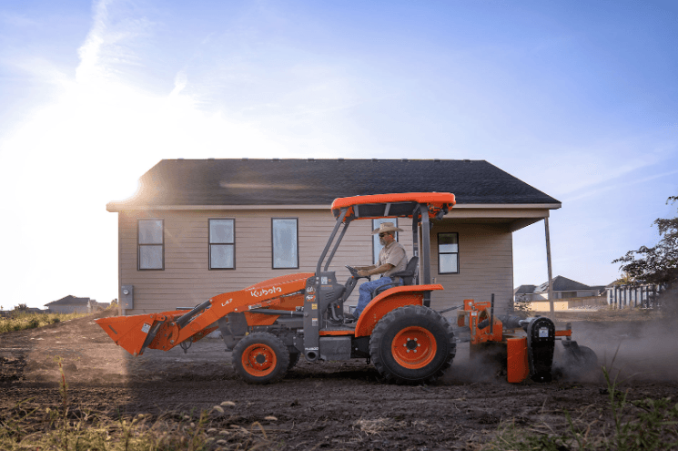 Man using a backhoe on a residential site