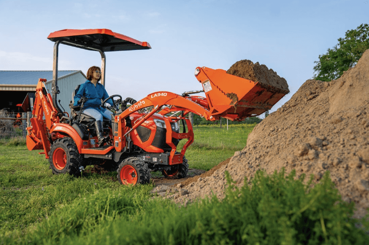 Woman moving dirt with the Kubota BX23S front loader