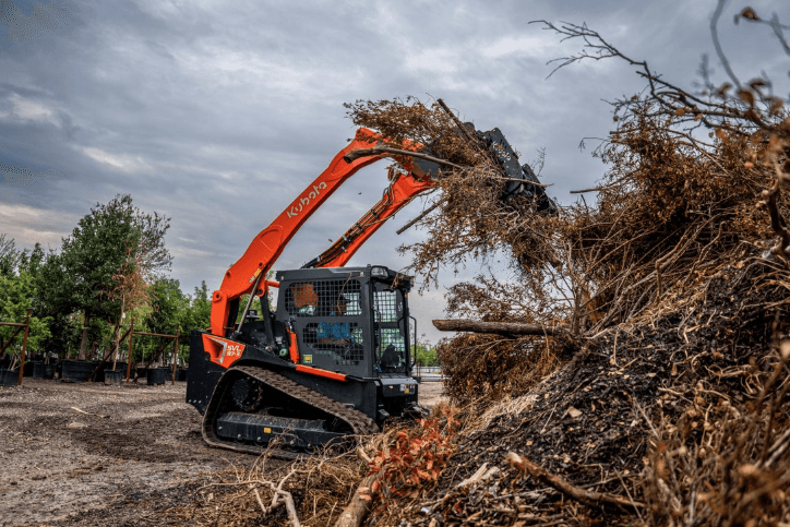 Track Loader moving debris from pile