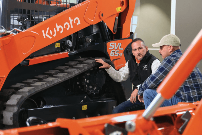 Kubota employee showing the svl65-2 model