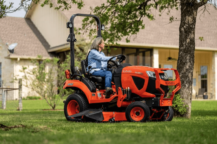 Woman using mower to mow yard
