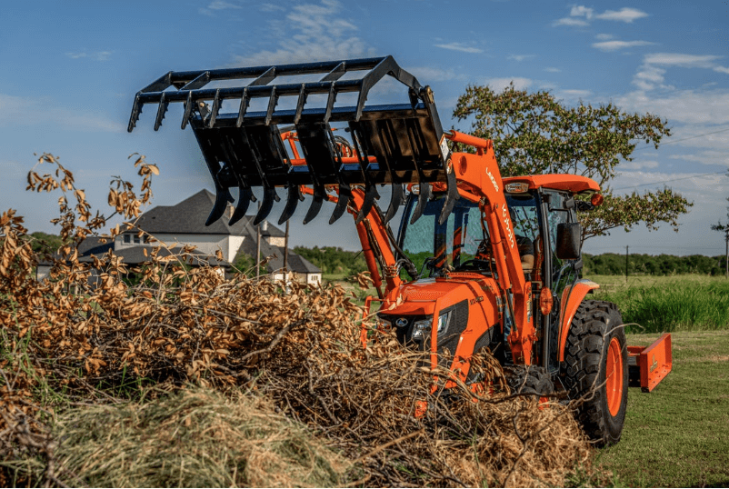 Tractor dumping debris onto