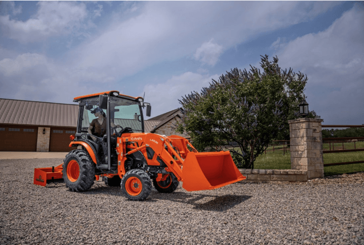 Woman using box blade to smooth out gravel driveway 