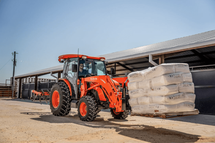Tractor moving a pallet of heavy materials