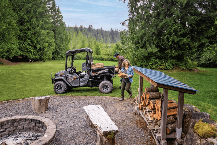 Couple using RTV to unload firewood 