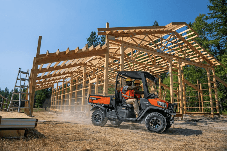 Construction workers using RTV to transport tools and crew