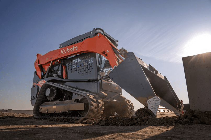 Close up of track loader scooping