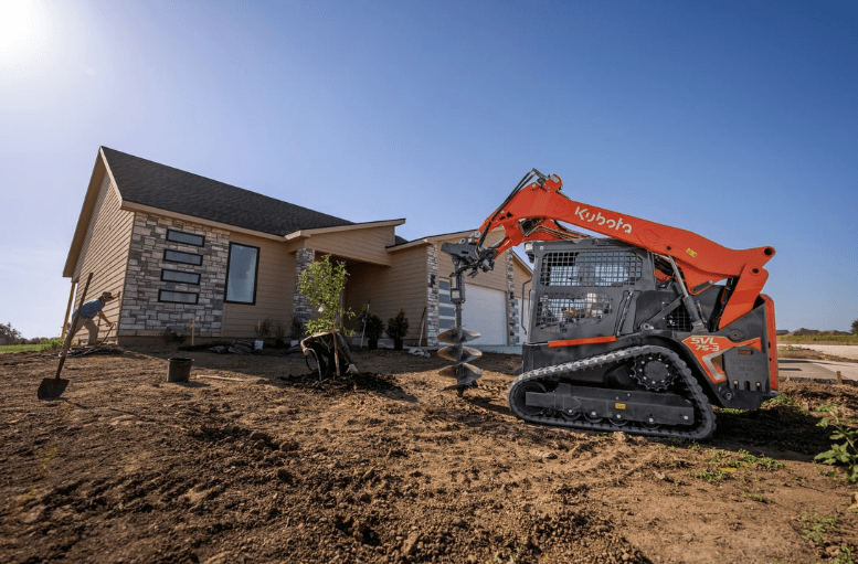 Track loader working on landscaping