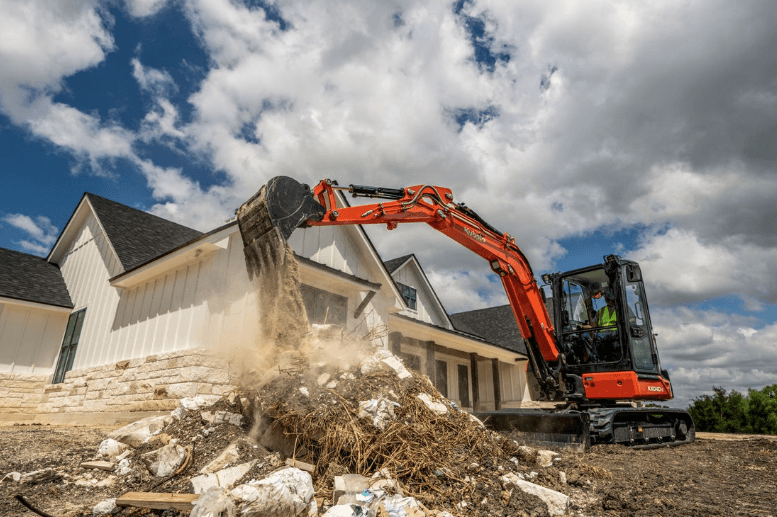 Excavator moving debris