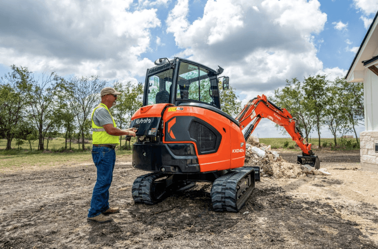 Man servicing his excavator 